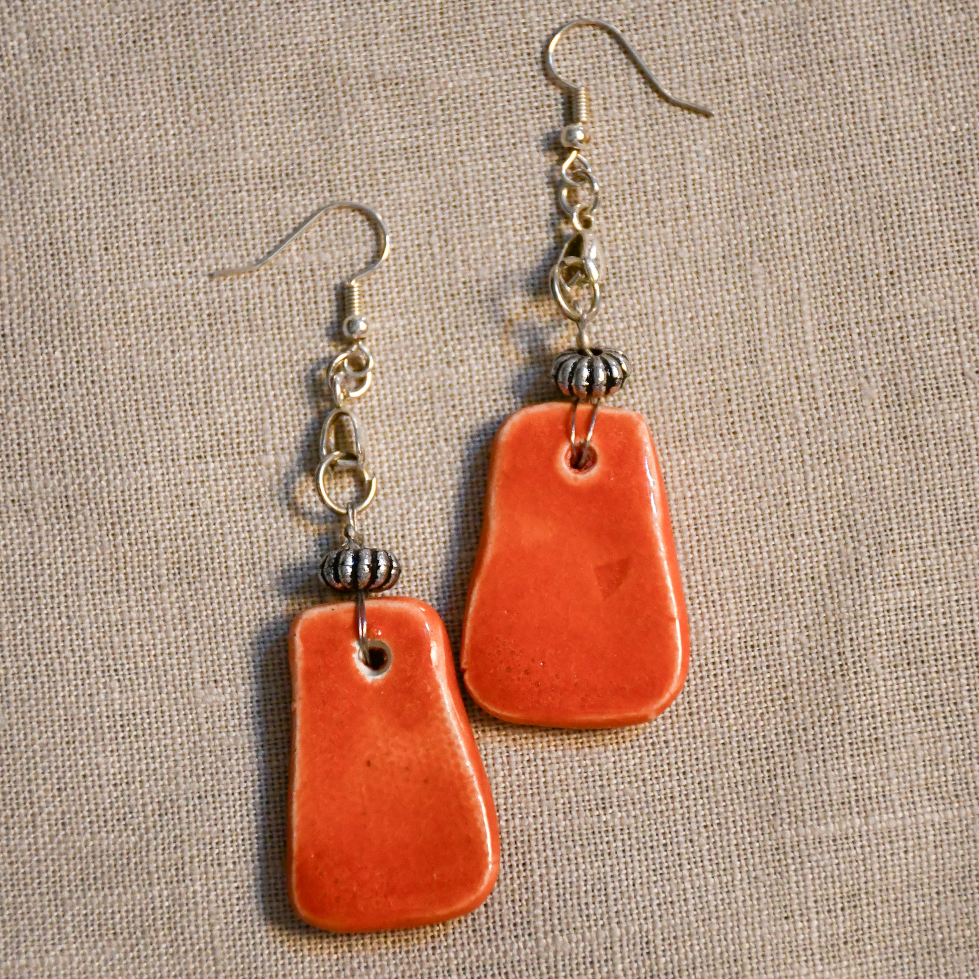 Handmade ceramic stamped dangle earrings by Leigh Art.