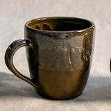 Handmade ceramic mug by Leigh Art featuring Espuela glaze with one-of-a-kind earth-tone movement and wheel-thrown craftsmanship.