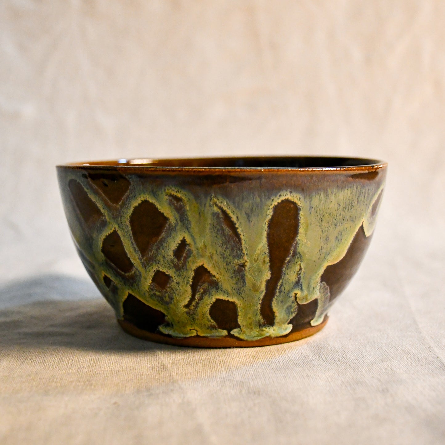 Handmade ceramic chili bowl by Leigh Art featuring Espuela glaze with one-of-a-kind earth-tone movement and wheel-thrown craftsmanship.