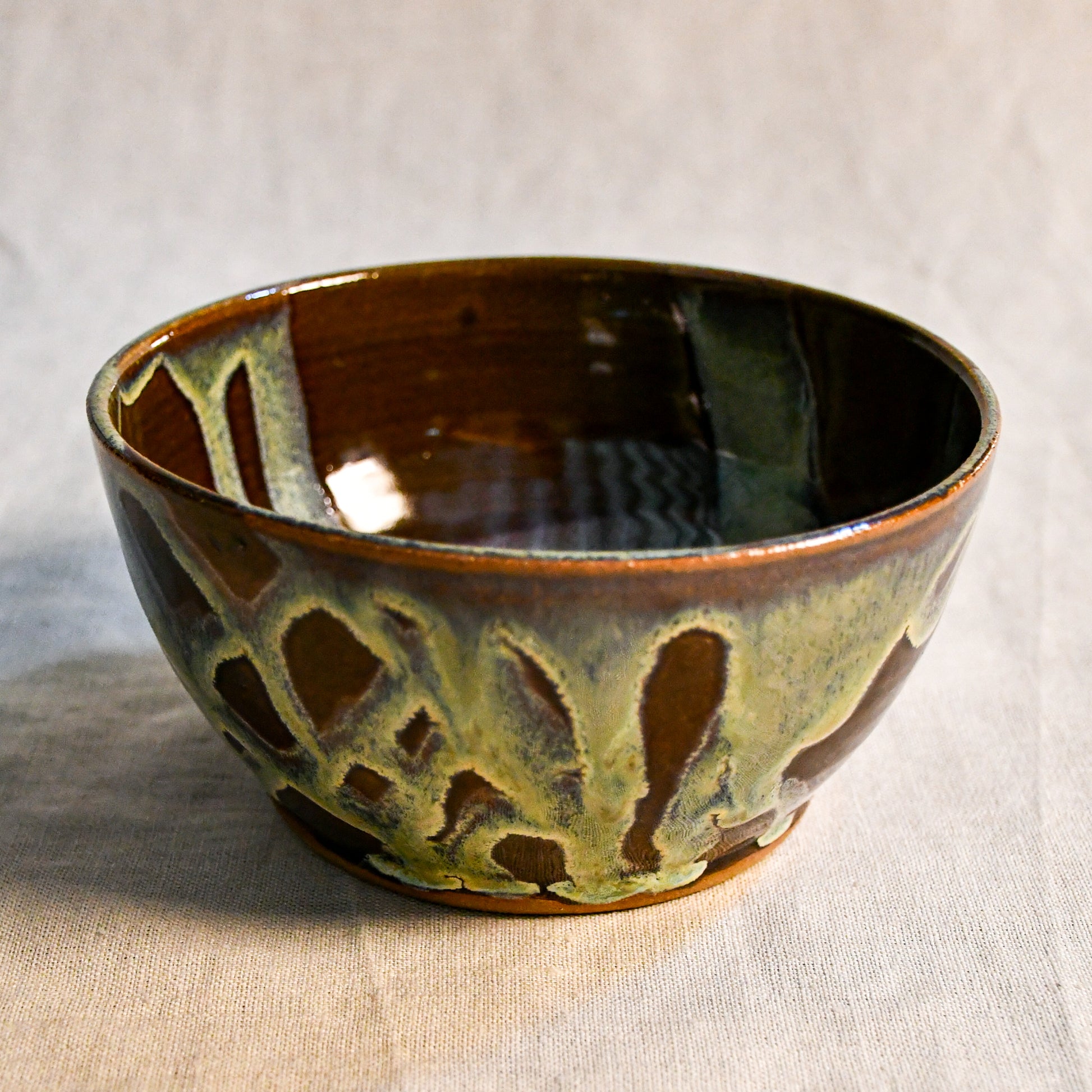 Handmade ceramic chili bowl by Leigh Art featuring Espuela glaze with one-of-a-kind earth-tone movement and wheel-thrown craftsmanship.