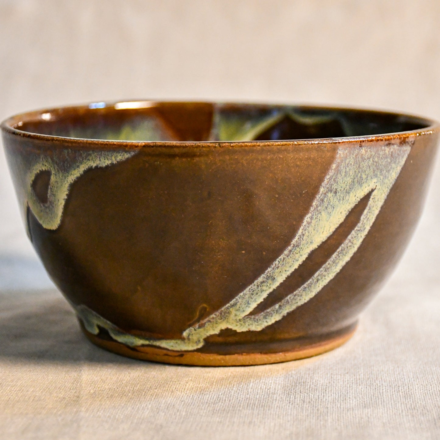 Handmade ceramic chili bowl by Leigh Art featuring Espuela glaze with one-of-a-kind earth-tone movement and wheel-thrown craftsmanship.