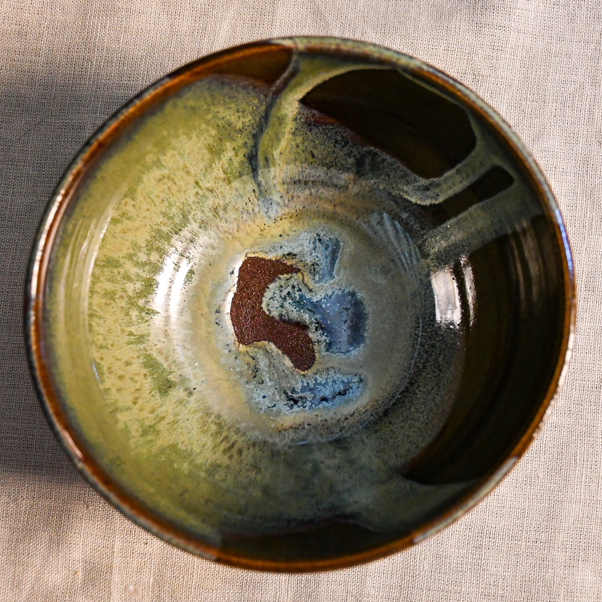 Handmade ceramic chili bowl by Leigh Art featuring Espuela glaze with one-of-a-kind earth-tone movement and wheel-thrown craftsmanship.