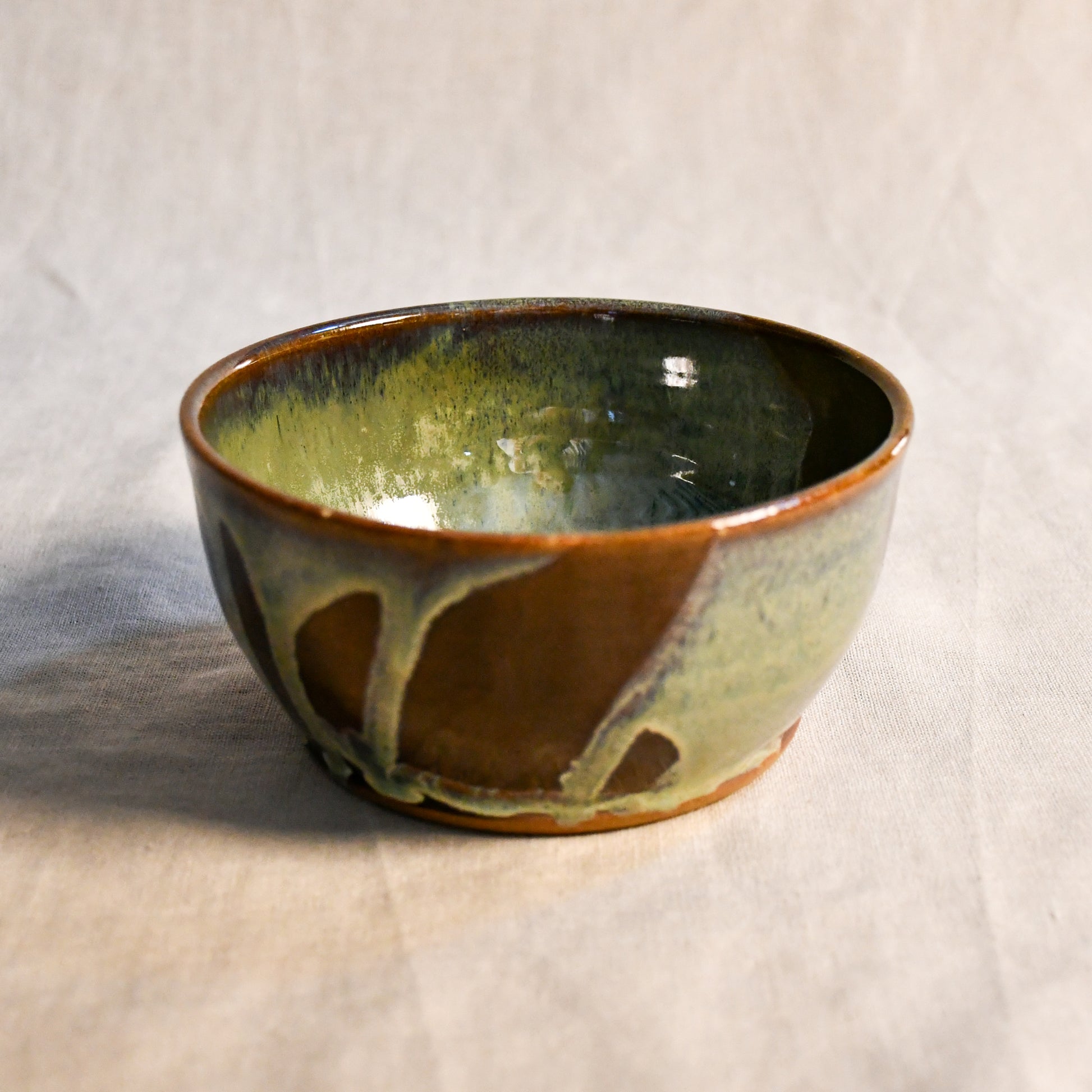 Handmade ceramic chili bowl by Leigh Art featuring Espuela glaze with one-of-a-kind earth-tone movement and wheel-thrown craftsmanship.