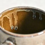 Handmade ceramic mug by Leigh Art featuring Espuela glaze with one-of-a-kind earth-tone movement and wheel-thrown craftsmanship.