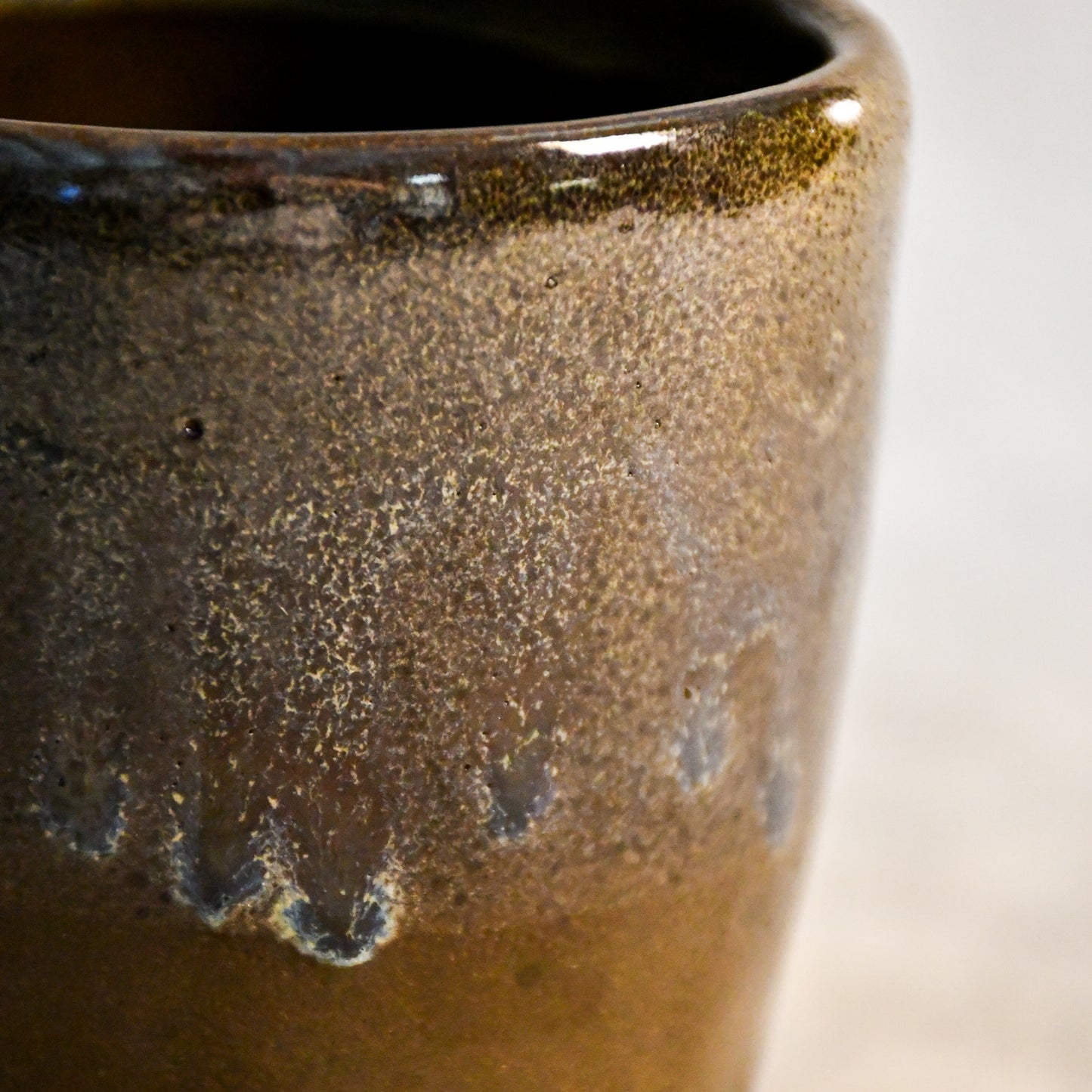 Handmade ceramic mug by Leigh Art featuring Espuela glaze with one-of-a-kind earth-tone movement and wheel-thrown craftsmanship.