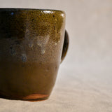 Handmade ceramic mug by Leigh Art featuring Espuela glaze with one-of-a-kind earth-tone movement and wheel-thrown craftsmanship.