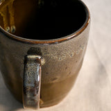 Handmade ceramic mug by Leigh Art featuring Espuela glaze with one-of-a-kind earth-tone movement and wheel-thrown craftsmanship.
