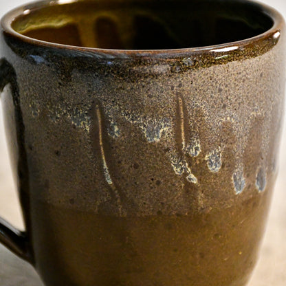 Handmade ceramic mug by Leigh Art featuring Espuela glaze with one-of-a-kind earth-tone movement and wheel-thrown craftsmanship.