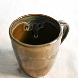 Handmade ceramic mug by Leigh Art featuring Espuela glaze with one-of-a-kind earth-tone movement and wheel-thrown craftsmanship.
