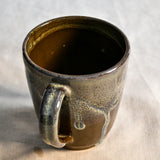 Handmade ceramic mug by Leigh Art featuring Espuela glaze with one-of-a-kind earth-tone movement and wheel-thrown craftsmanship.
