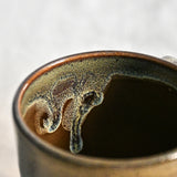 Handmade ceramic mug by Leigh Art featuring Espuela glaze with one-of-a-kind earth-tone movement and wheel-thrown craftsmanship.