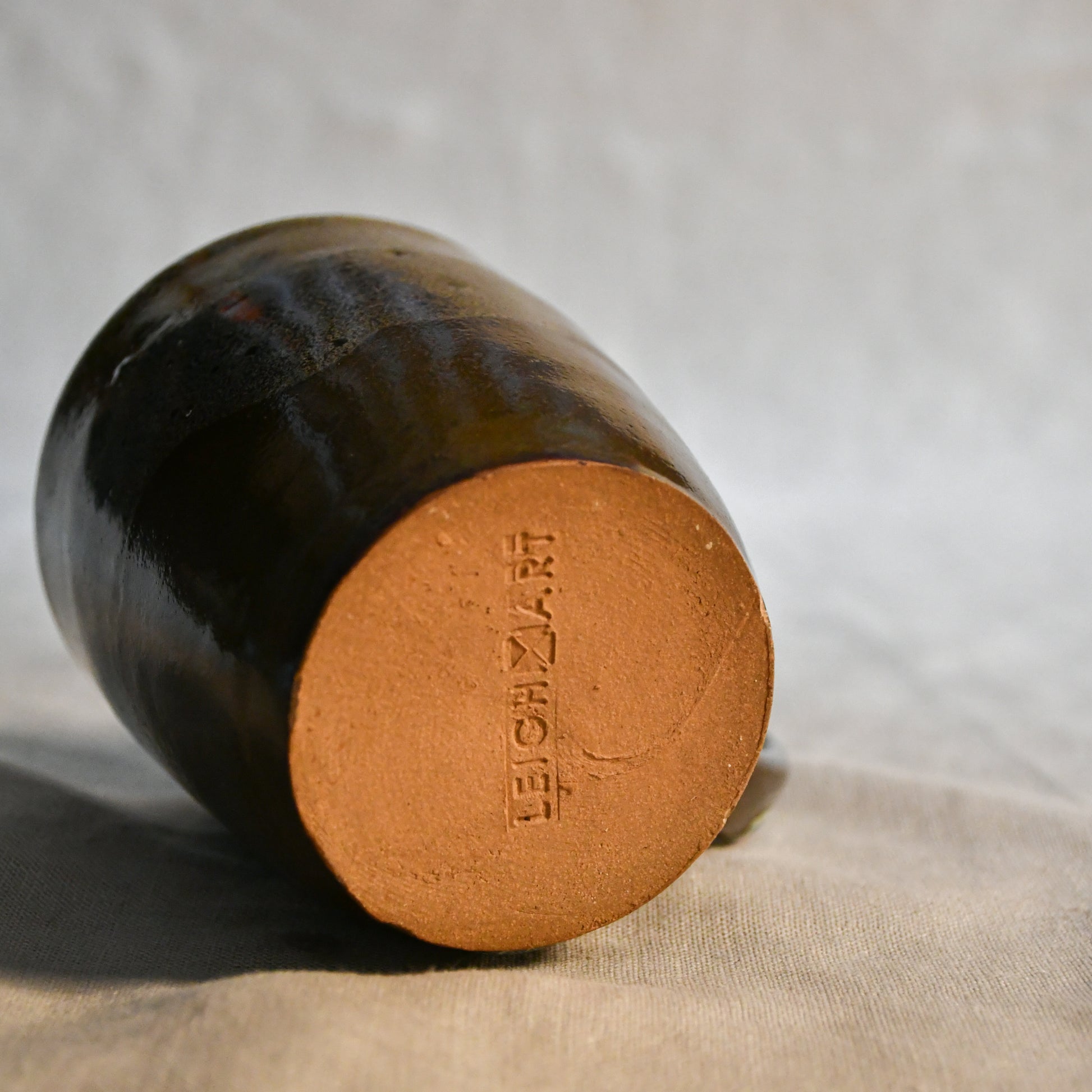 Handmade ceramic mug by Leigh Art featuring Espuela glaze with one-of-a-kind earth-tone movement and wheel-thrown craftsmanship.