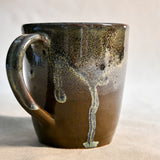 Handmade ceramic mug by Leigh Art featuring Espuela glaze with one-of-a-kind earth-tone movement and wheel-thrown craftsmanship.