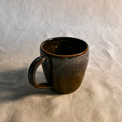 Handmade ceramic mug by Leigh Art featuring Espuela glaze with one-of-a-kind earth-tone movement and wheel-thrown craftsmanship.