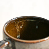 Handmade ceramic mug by Leigh Art featuring Espuela glaze with one-of-a-kind earth-tone movement and wheel-thrown craftsmanship.