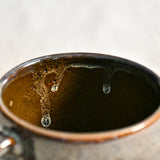 Handmade ceramic mug by Leigh Art featuring Espuela glaze with one-of-a-kind earth-tone movement and wheel-thrown craftsmanship.