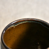 Handmade ceramic mug by Leigh Art featuring Espuela glaze with one-of-a-kind earth-tone movement and wheel-thrown craftsmanship.