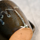 Handmade ceramic mug by Leigh Art featuring Espuela glaze with one-of-a-kind earth-tone movement and wheel-thrown craftsmanship.