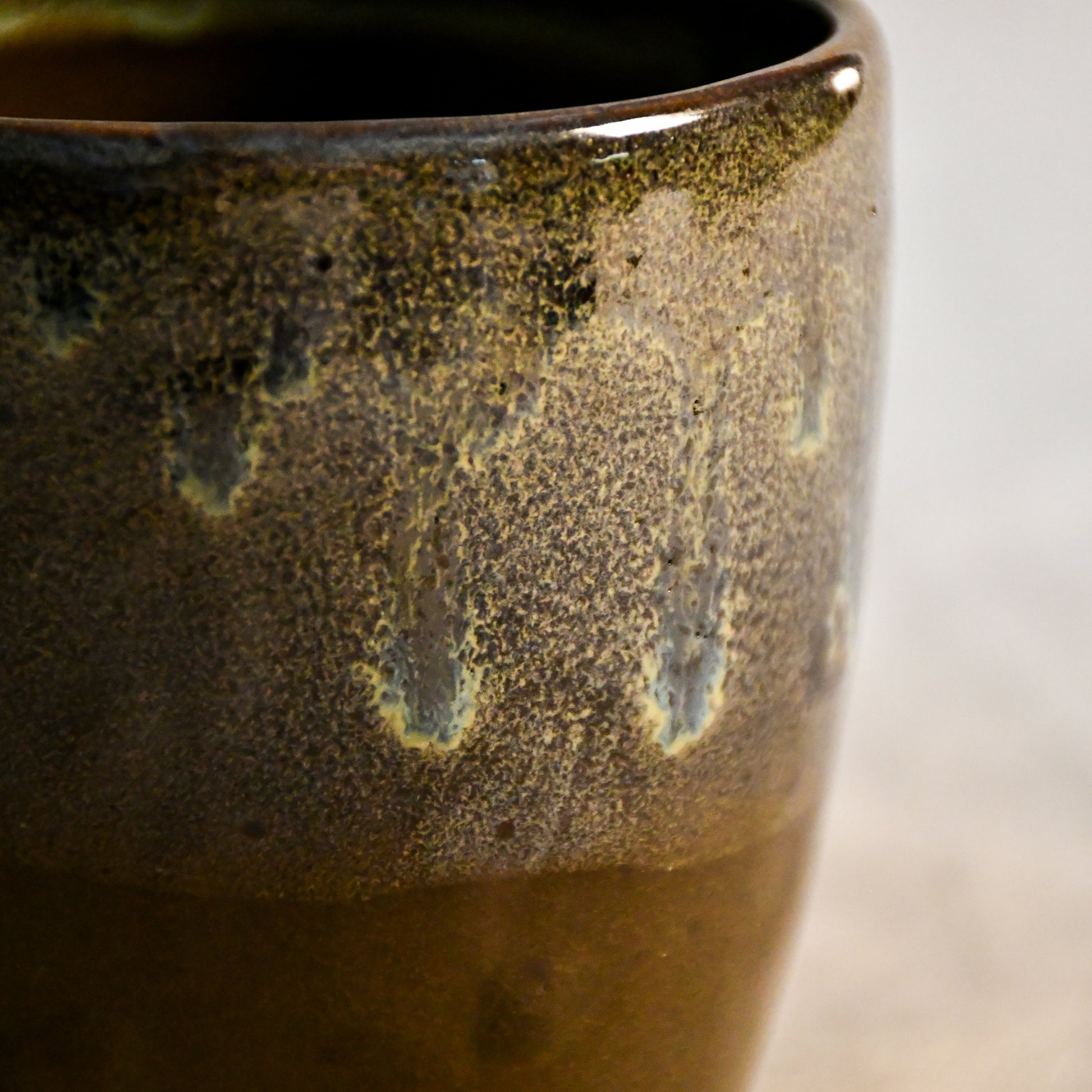 Handmade ceramic mug by Leigh Art featuring Espuela glaze with one-of-a-kind earth-tone movement and wheel-thrown craftsmanship.