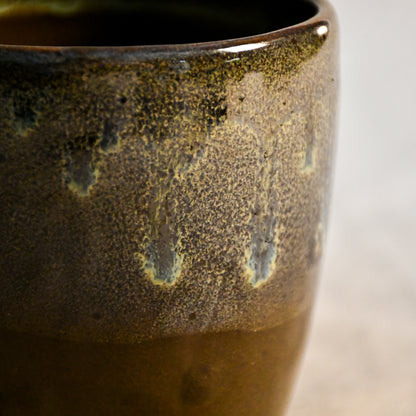 Handmade ceramic mug by Leigh Art featuring Espuela glaze with one-of-a-kind earth-tone movement and wheel-thrown craftsmanship.