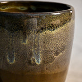 Handmade ceramic mug by Leigh Art featuring Espuela glaze with one-of-a-kind earth-tone movement and wheel-thrown craftsmanship.
