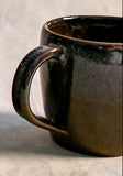 Handmade ceramic mug by Leigh Art featuring Espuela glaze with one-of-a-kind earth-tone movement and wheel-thrown craftsmanship.