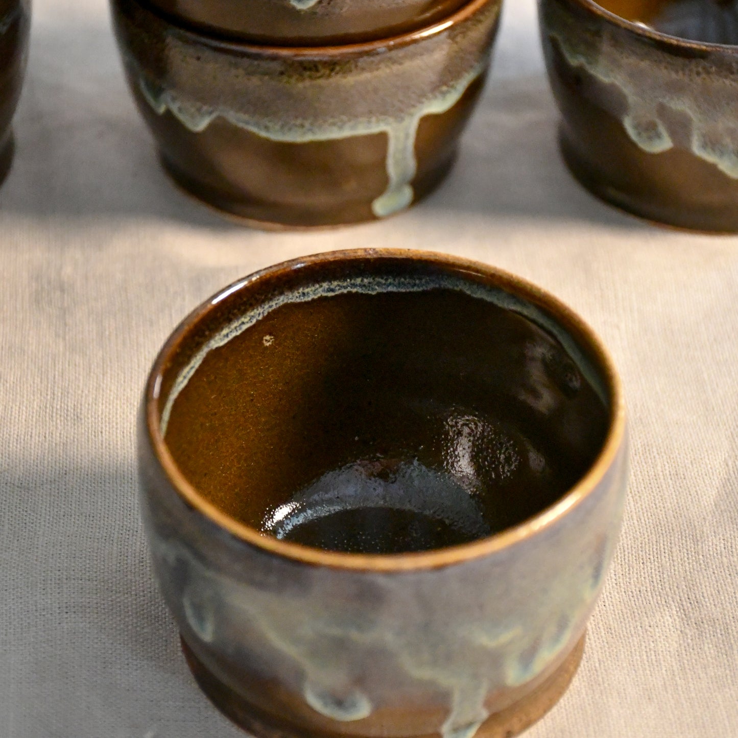 Handmade ceramic salsa bowl by Leigh Art featuring Espuela glaze with one-of-a-kind earth-tone movement and wheel-thrown craftsmanship.