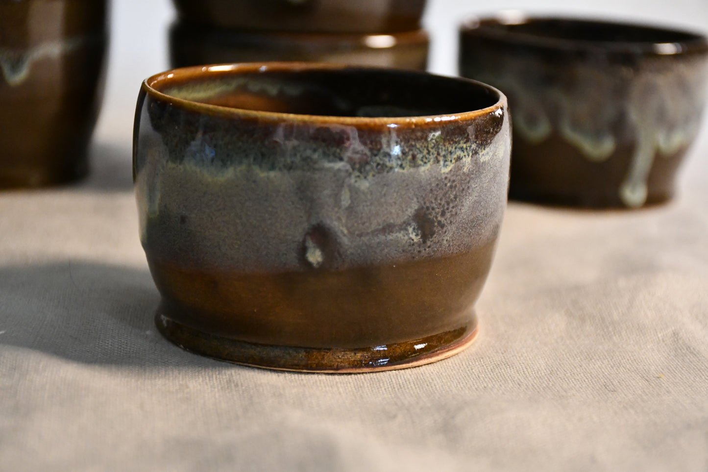 Handmade ceramic salsa bowl by Leigh Art featuring Espuela glaze with one-of-a-kind earth-tone movement and wheel-thrown craftsmanship.