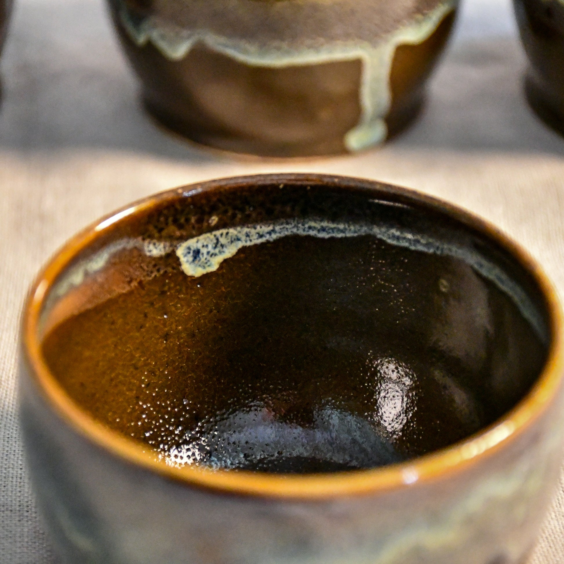 Handmade ceramic salsa bowl by Leigh Art featuring Espuela glaze with one-of-a-kind earth-tone movement and wheel-thrown craftsmanship.