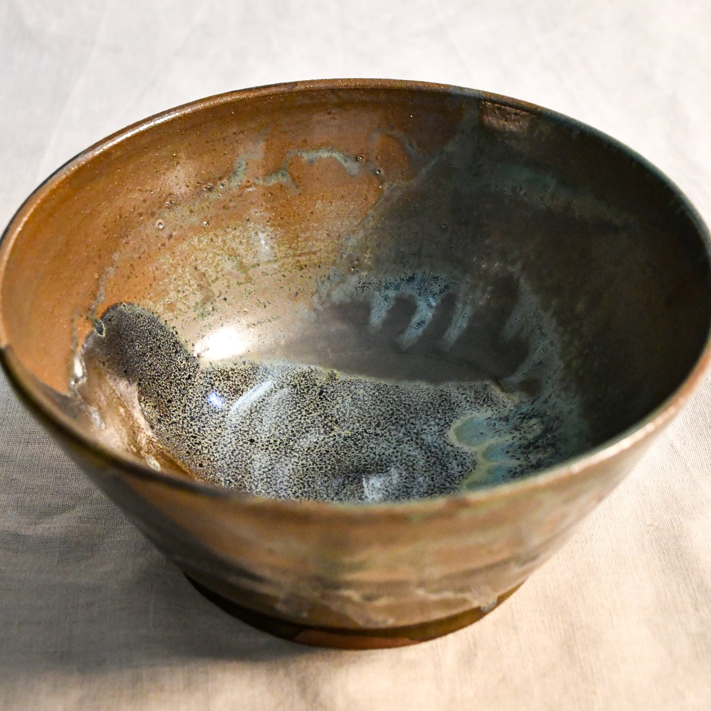 Interior view of a handcrafted Espuela serving bowl highlighting the layered glaze movement and natural variation.