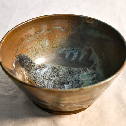 Interior view of a handcrafted Espuela serving bowl highlighting the layered glaze movement and natural variation.