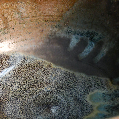 Interior view of a handcrafted Espuela serving bowl highlighting the layered glaze movement and natural variation.