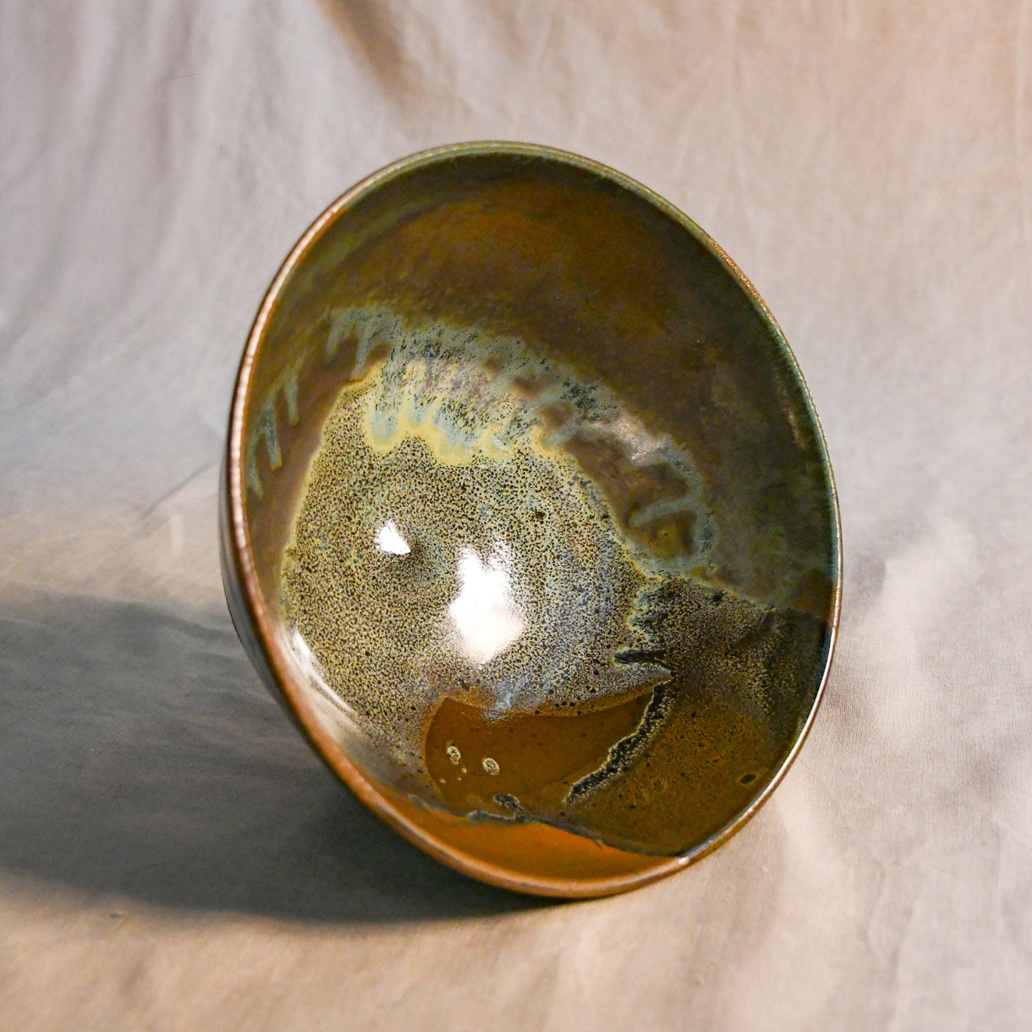 Interior view of a handcrafted Espuela serving bowl highlighting the layered glaze movement and natural variation.