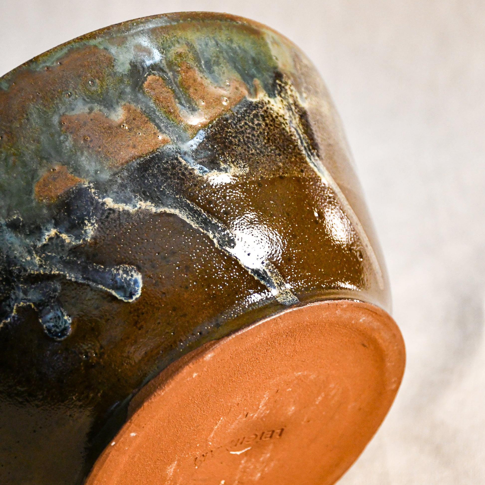 Handmade ceramic serving bowl from the Espuela Collection with an elegant silhouette and distinctive earth-tone glaze.