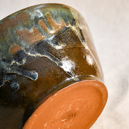 Handmade ceramic serving bowl from the Espuela Collection with an elegant silhouette and distinctive earth-tone glaze.