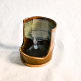 Handmade Espuela ceramic spoon rest by Leigh Art featuring layered earth-tone glaze with organic movement and one-of-a-kind variation.