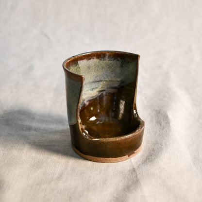 Handmade Espuela ceramic spoon rest by Leigh Art featuring layered earth-tone glaze with organic movement and one-of-a-kind variation.
