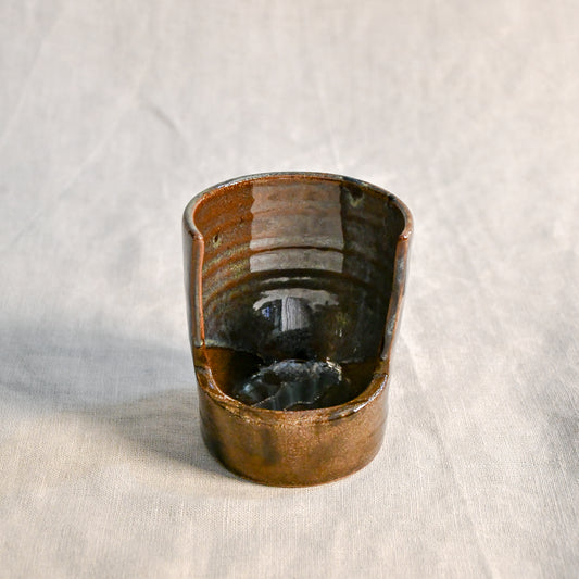 Handmade Espuela ceramic spoon rest by Leigh Art featuring layered earth-tone glaze with organic movement and one-of-a-kind variation.