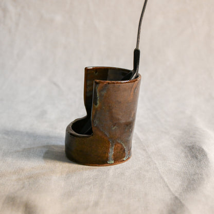 Handmade Espuela ceramic spoon rest by Leigh Art featuring layered earth-tone glaze with organic movement and one-of-a-kind variation.