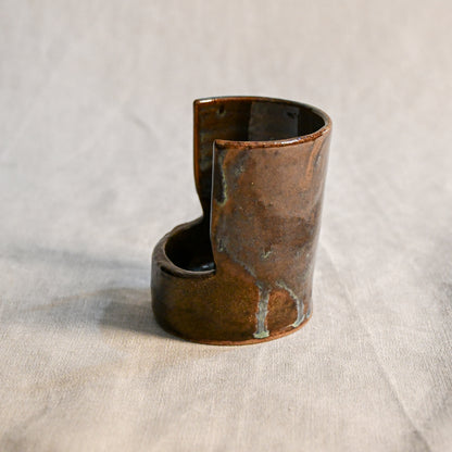 Handmade Espuela ceramic spoon rest by Leigh Art featuring layered earth-tone glaze with organic movement and one-of-a-kind variation.