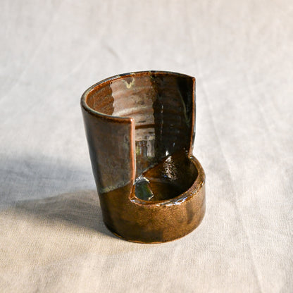 Handmade Espuela ceramic spoon rest by Leigh Art featuring layered earth-tone glaze with organic movement and one-of-a-kind variation.