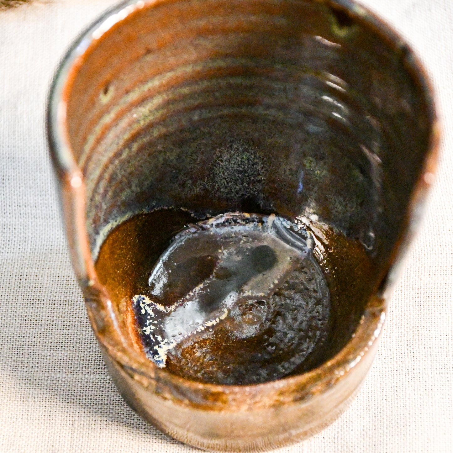 Handmade Espuela ceramic spoon rest by Leigh Art featuring layered earth-tone glaze with organic movement and one-of-a-kind variation.