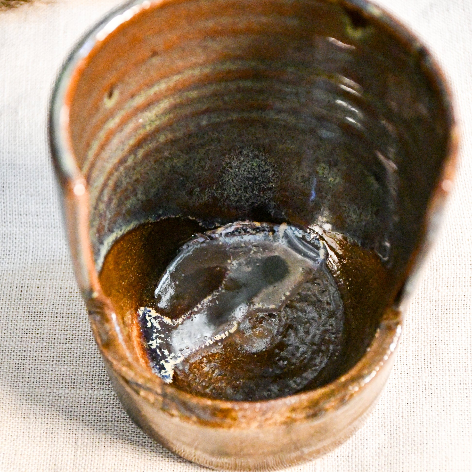 Handmade Espuela ceramic spoon rest by Leigh Art featuring layered earth-tone glaze with organic movement and one-of-a-kind variation.