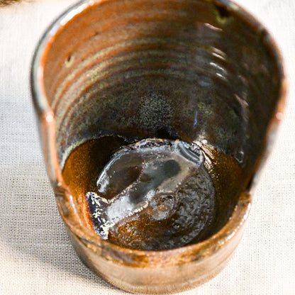 Handmade Espuela ceramic spoon rest by Leigh Art featuring layered earth-tone glaze with organic movement and one-of-a-kind variation.