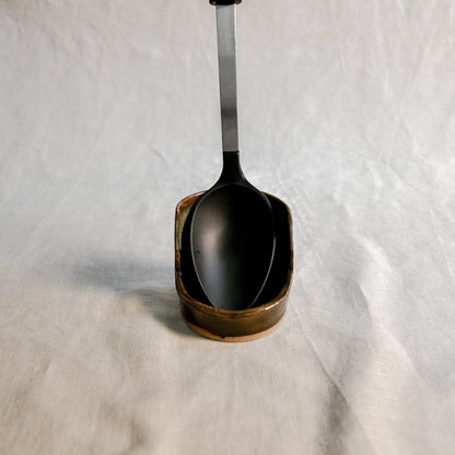 Handmade Espuela ceramic spoon rest by Leigh Art featuring layered earth-tone glaze with organic movement and one-of-a-kind variation.