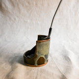 Handmade Espuela ceramic spoon rest by Leigh Art featuring layered earth-tone glaze with organic movement and one-of-a-kind variation.