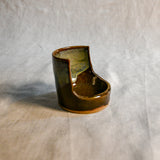 Handmade Espuela ceramic spoon rest by Leigh Art featuring layered earth-tone glaze with organic movement and one-of-a-kind variation.