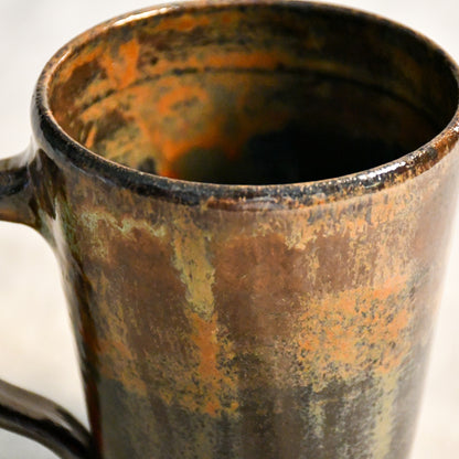 Detailed view of the Ancient Jasper glaze on a handcrafted ceramic mug, showcasing organic rust, olive, charcoal, and brown textures.