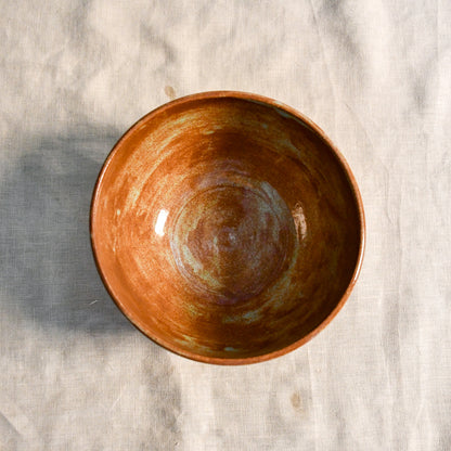 Handmade wheel-thrown stoneware chili bowl featuring Heirloom Blue glaze with rich rust tones and soft blue-green highlights inside the bowl.