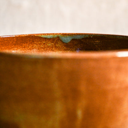 Close-up of the rim of a wheel-thrown ceramic chili bowl featuring Heirloom Blue glaze with blue-green accents and warm earthy tones.